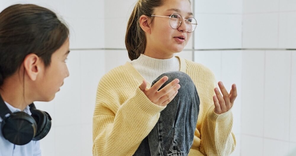 Portrait of teenage girl sharing feelings in support group circle for children